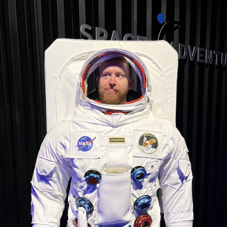 Making a funny face while wearing a NASA space suit.